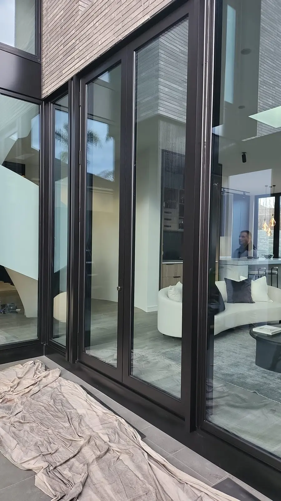 Black resprayed aluminium window frames on a modern home